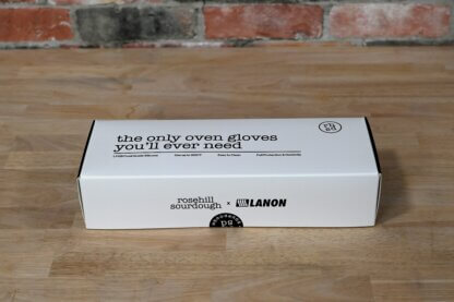 Closed box showing the text "the only oven gloves you'll ever need" with four descriptions: "LFGB Food Grade Silicone", "Use up to 500F", "Easy to Clean", and "Full Protection and Dexterity". Box is labeled with rosehill sourdough and Lanon.